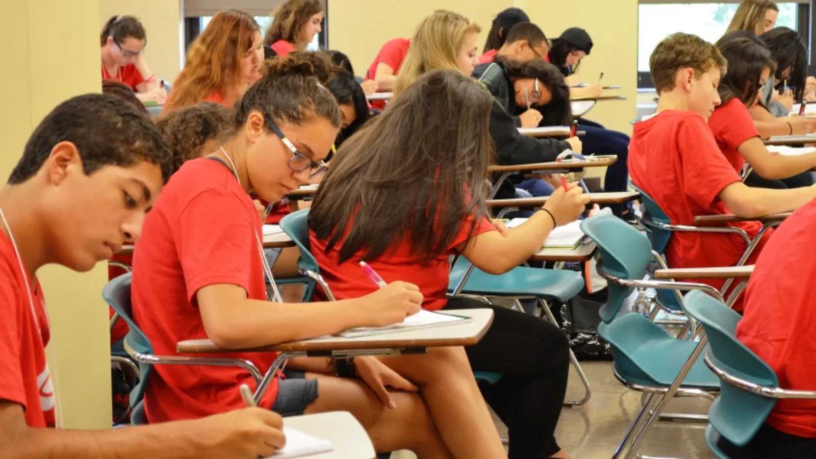 Scholars taking notes during a lecture