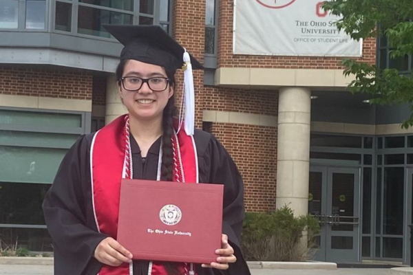 Florencia Ontiveros with diploma after graduation ceremony