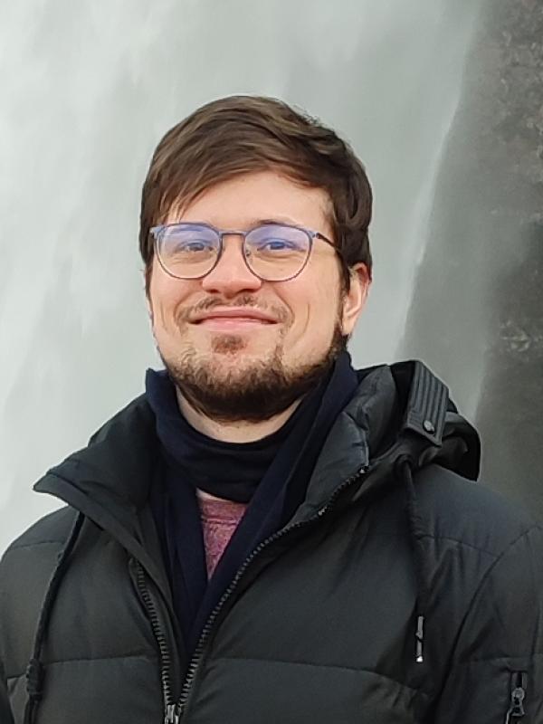 Vlad Khvostov smiling in front of waterfall