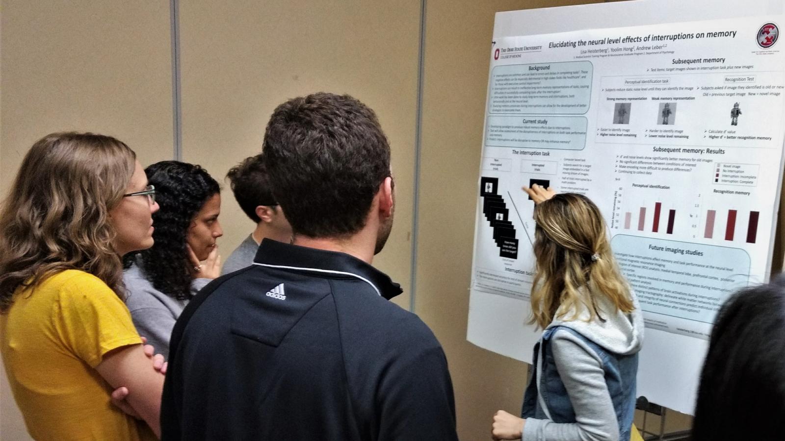 Student presenting her research poster to attendees